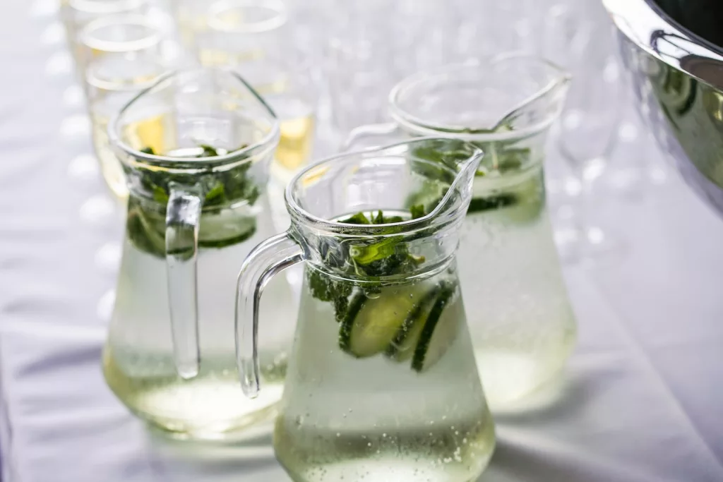 clear glass pitcher with content, okra and cucumber water