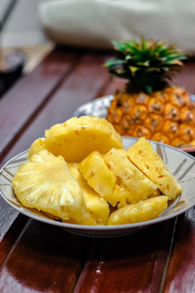 sliced pineapple on white ceramic plate, pineapple in your diet