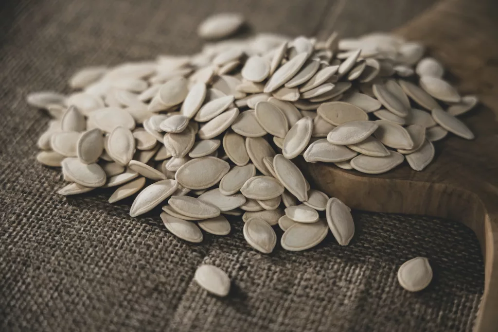 brown seeds on brown wooden surface, pumpkin seeds, super seeds