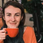 a woman holding a cup of coffee in front of her face, boost your immune system