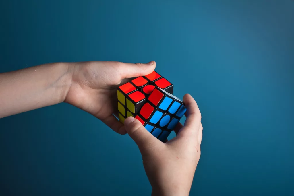 person playing magic cube, solving puzzles - one of the ways to taking care of your health