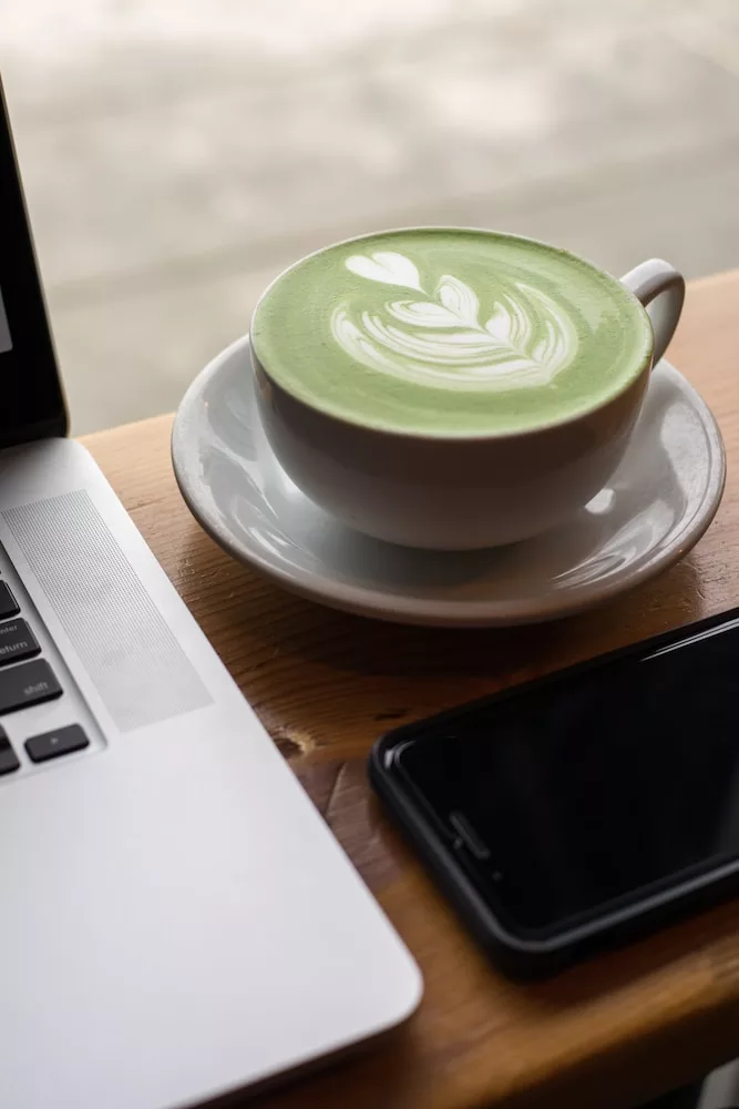 white ceramic teacup on top of white saucer, matcha latte to boost your immune system