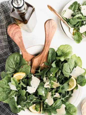 brown wooden spoon on green vegetable, spinach salad with quinoa