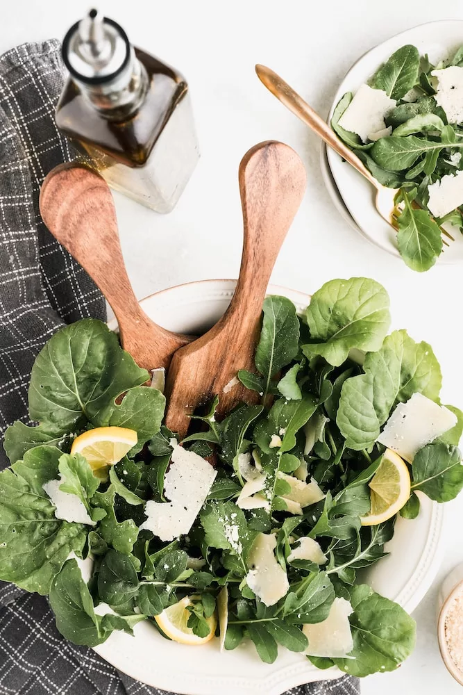 brown wooden spoon on green vegetable, spinach salad with quinoa