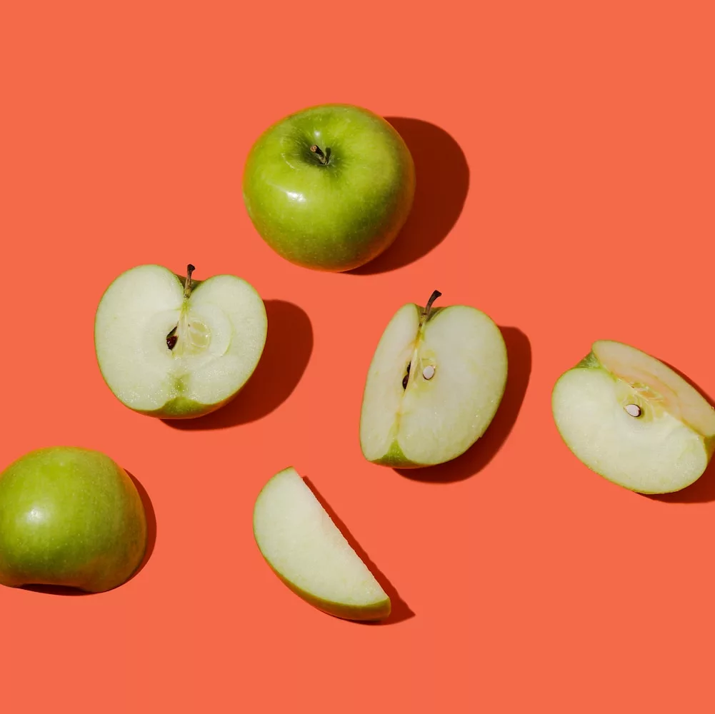 green apple fruit on pink surface, benefits of apples