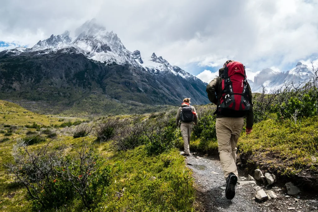 natural remedies for stress relief, two person walking towards mountain covered with snow