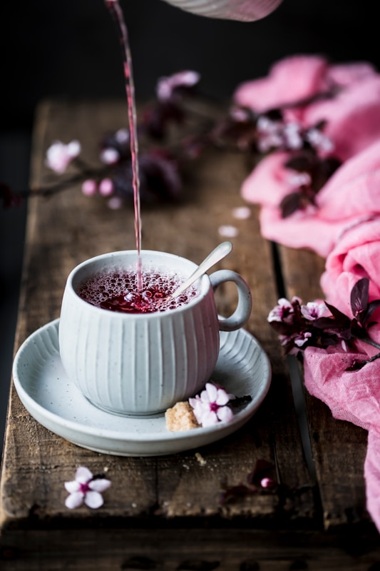 a cup of tea being poured into it