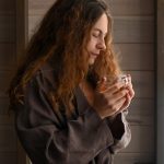 a woman holding a glass | morning routine for good health