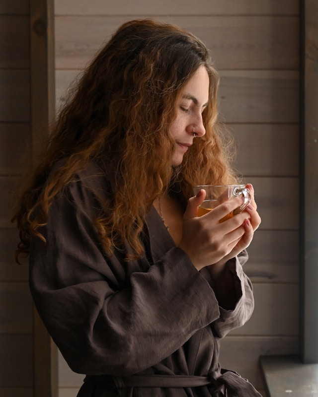 a woman holding a glass | morning routine for good health