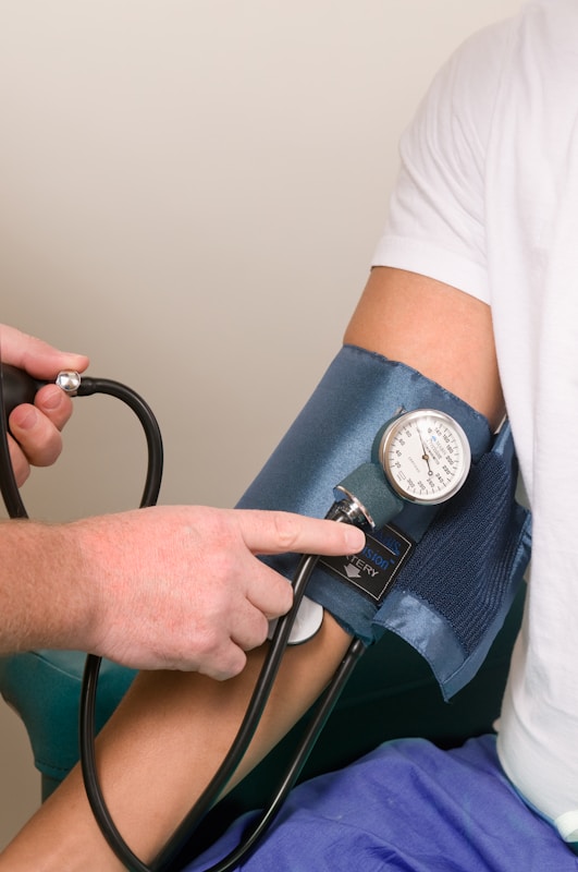 a doctor checking the blood pressure of a patient | signs of high blood pressure
