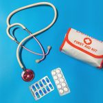 a bag of pills, a stethoscope, and a first aid kit | home emergency kit