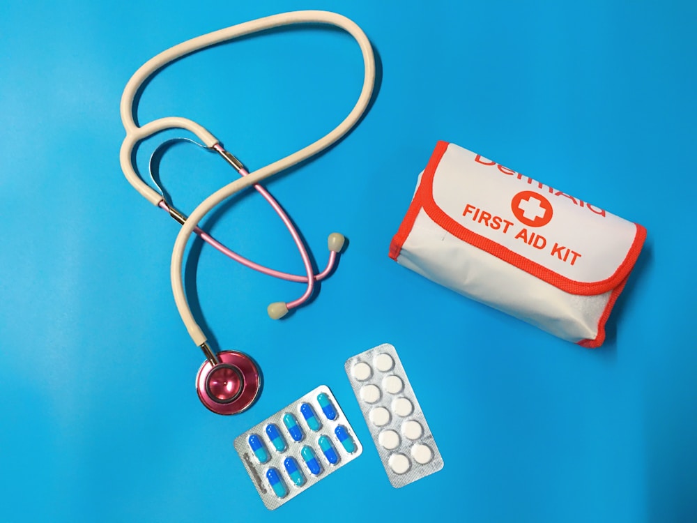 a bag of pills, a stethoscope, and a first aid kit | home emergency kit
