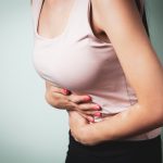 A person holding their stomach in pain.